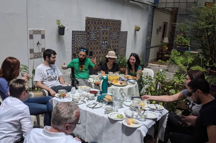 The group sitting around a long table in a tiled Buenos Aires patio