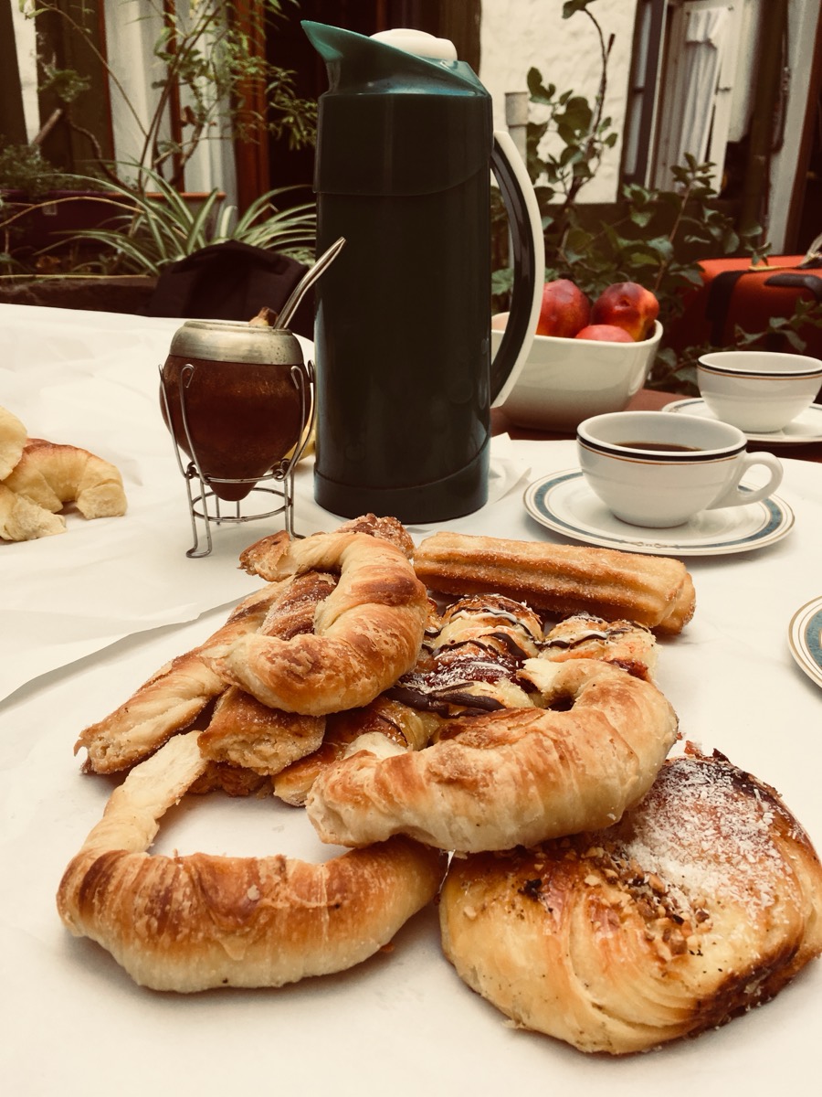 Medialunas, coffee and a mate on a breakfast table in Buenos Aires